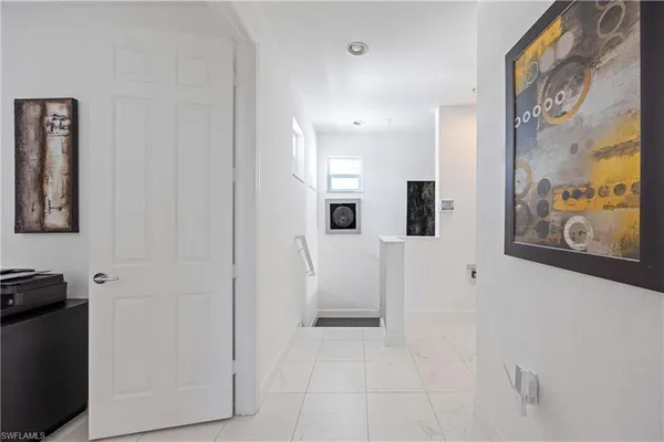 a view of a hallway with paintings on the wall