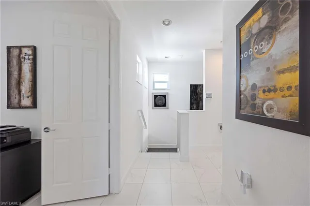 a view of a hallway with paintings on the wall