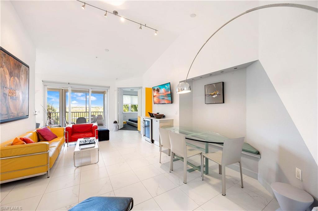 4685 Hawks Nest Way, Unit J201 Naples, FL 34114 - Photo 6 of 24 a living room with furniture and a window