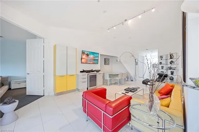 a living room with furniture a rug and a chandelier