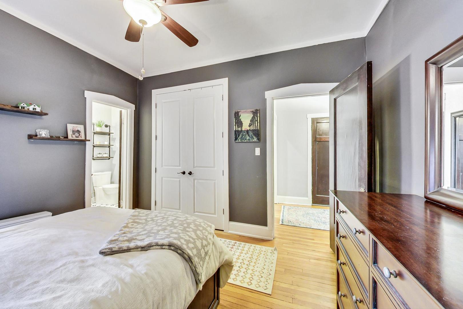 742 West Bittersweet Place, Unit 2W Chicago, IL 60613 - Photo 11 of 21 a spacious bedroom with a large bed and a chandelier