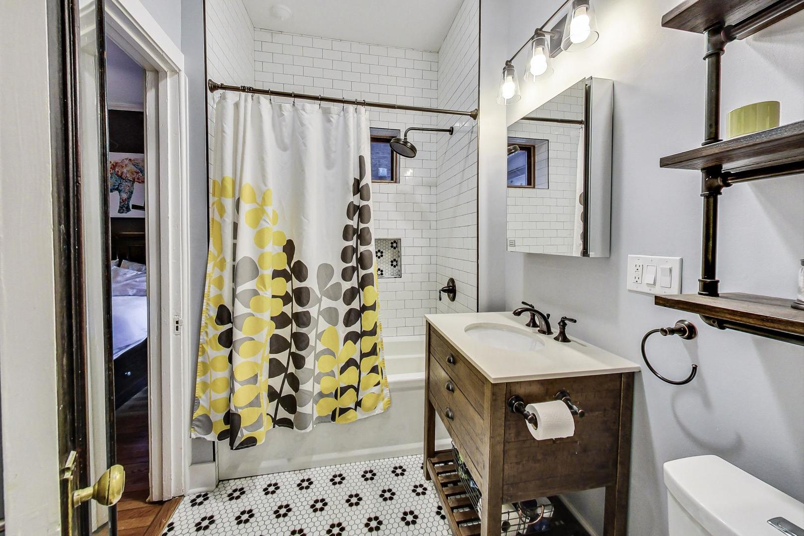 742 West Bittersweet Place, Unit 2W Chicago, IL 60613 - Photo 12 of 21 a bathroom with a sink toilet and shower