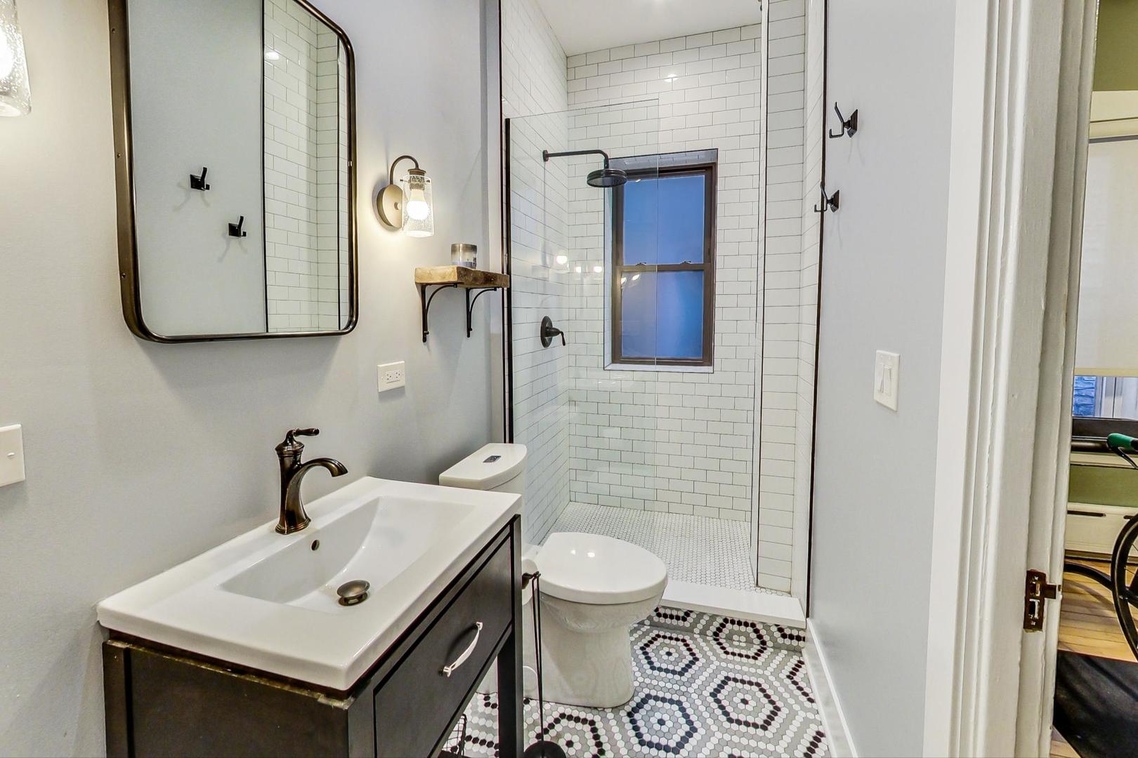 742 West Bittersweet Place, Unit 2W Chicago, IL 60613 - Photo 15 of 21 a bathroom with a sink and a mirror