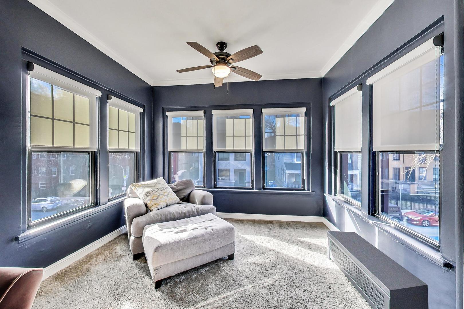 742 West Bittersweet Place, Unit 2W Chicago, IL 60613 - Photo 5 of 21 a living room with furniture and a large window