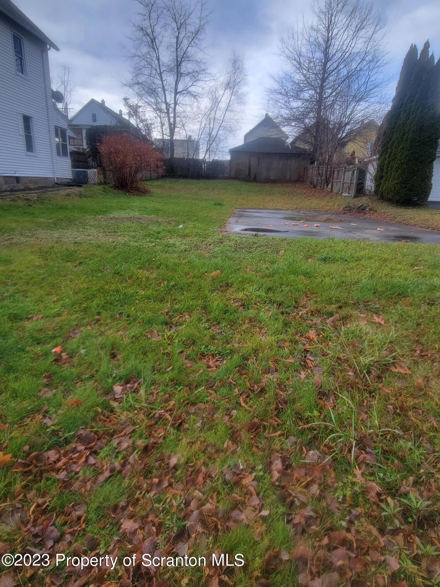 a view of a yard with a house in the background