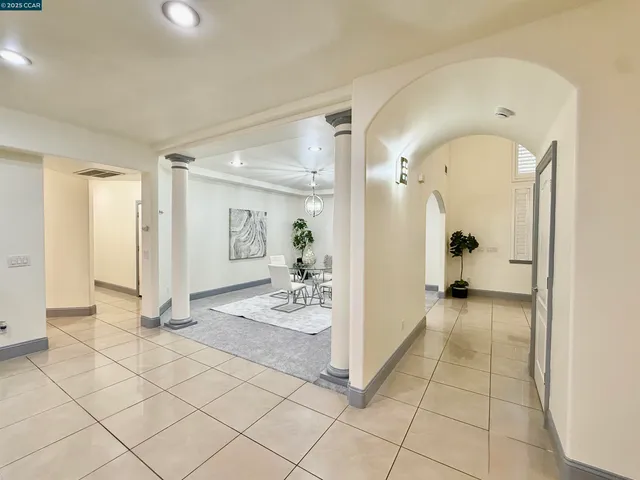 a view of a hallway with wooden floor and a living room