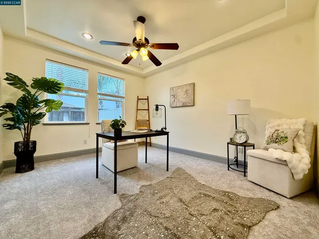 a living room with furniture a potted plant and a chandelier