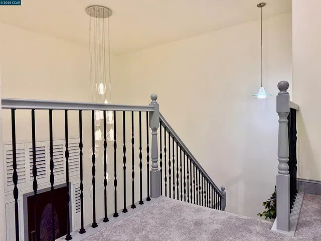 a view of staircase with railing