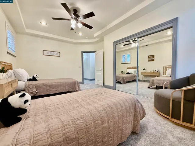 a bedroom with two beds and a chandelier