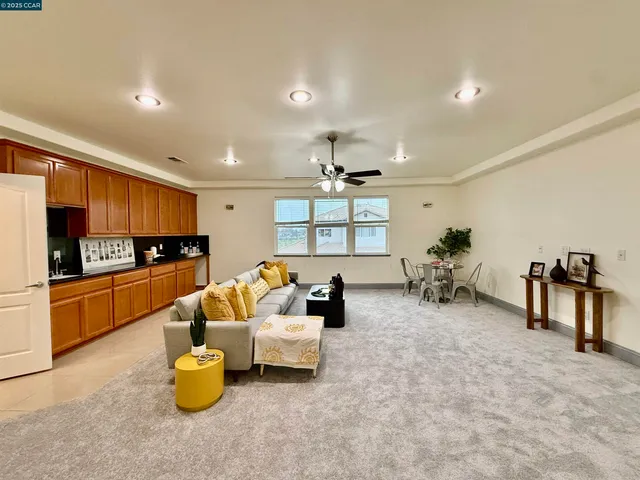 a living room with furniture and kitchen view