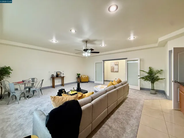 a living room with furniture and a chandelier