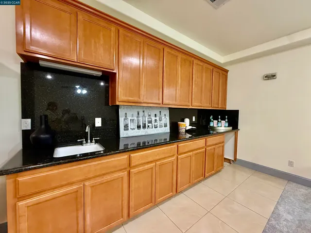 a kitchen with granite countertop stainless steel appliances and sink