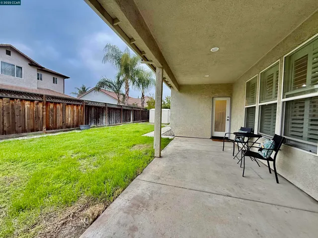 a view of house with backyard and a patio