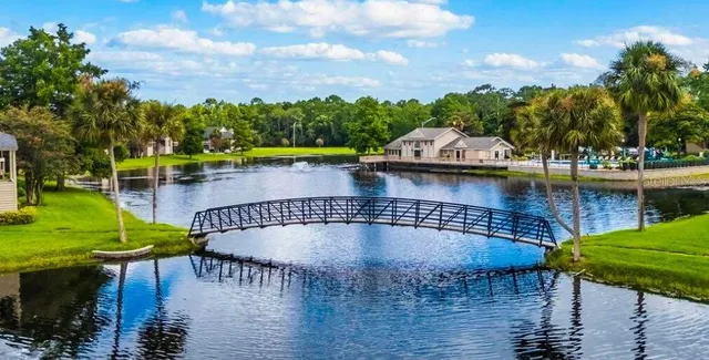 a living room with furniture and kitchen area