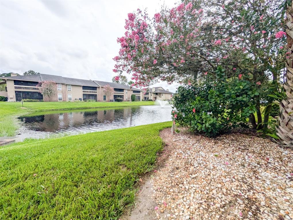 10200 Belle Rive Boulevard, Unit 241 Jacksonville, FL 32256 - Photo 2 of 25 a view of a garden with a building in the background