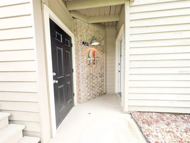 a view of a bedroom with a bed and glass door