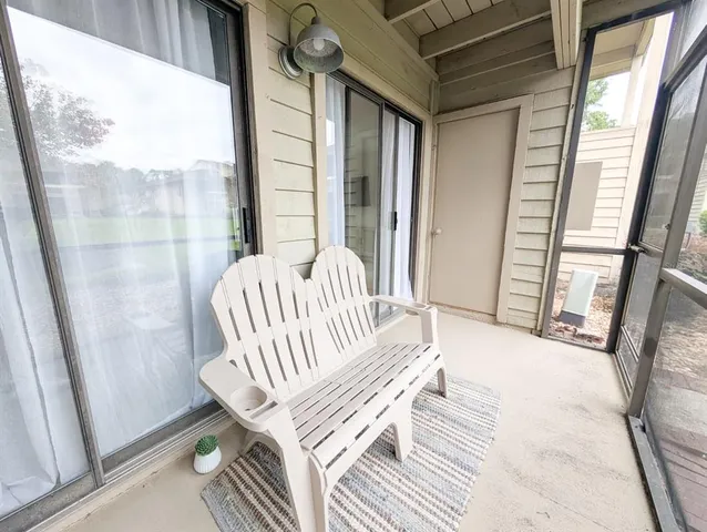 a view of a floor to ceiling window with wooden floor