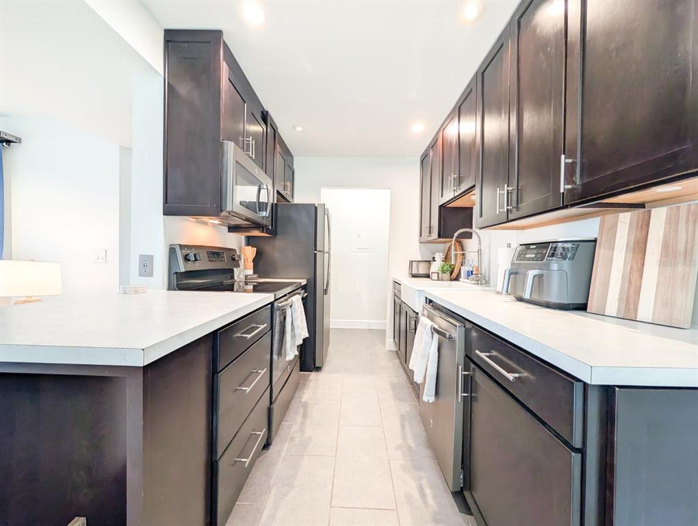 10200 Belle Rive Boulevard, Unit 241 Jacksonville, FL 32256 - Photo 4 of 25 a kitchen with stainless steel appliances granite countertop a sink a stove and a refrigerator