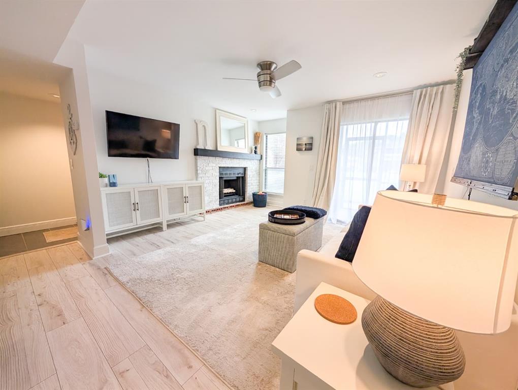 10200 Belle Rive Boulevard, Unit 241 Jacksonville, FL 32256 - Photo 5 of 25 a living room with furniture a flat screen tv and a fireplace