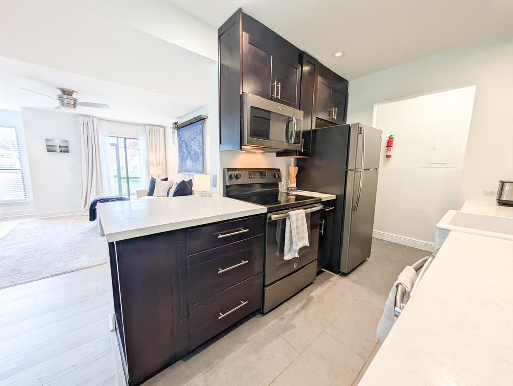 10200 Belle Rive Boulevard, Unit 241 Jacksonville, FL 32256 - Photo 6 of 25 a kitchen with stainless steel appliances a refrigerator a sink a stove and cabinets