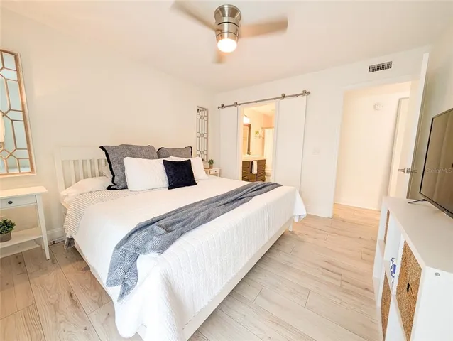 a bedroom with a bed and a window