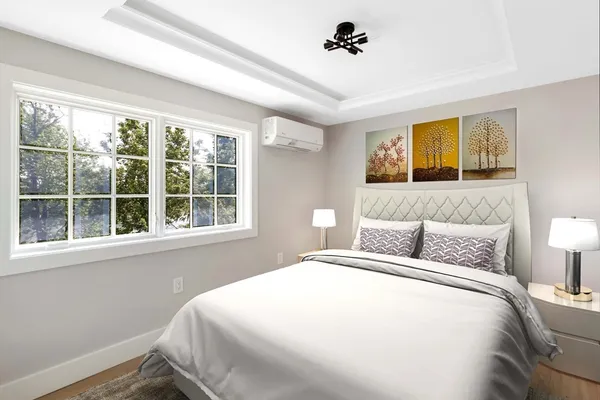 a bedroom with a large bed and a window