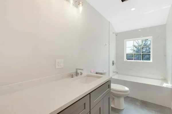 a bathroom with a sink toilet and vanity