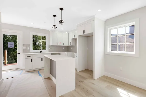 a view of a kitchen with a sink dishwasher a refrigerator and cabinets