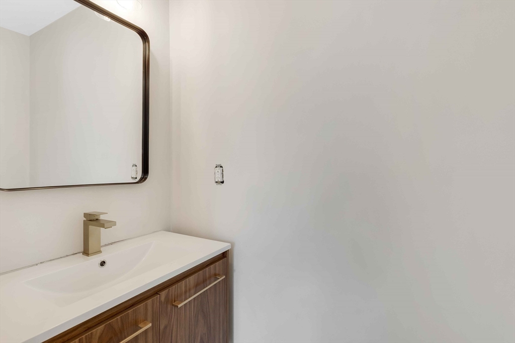 8 Crystal Street, Unit 3 Melrose, MA 02176 - Photo 10 of 24 a bathroom with a sink and a mirror