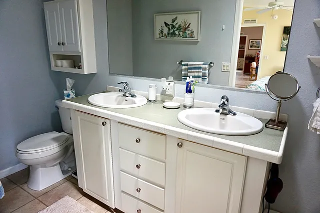 a bathroom with a toilet sink and mirror