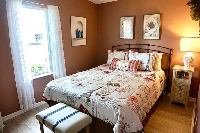 a bedroom with bed and window