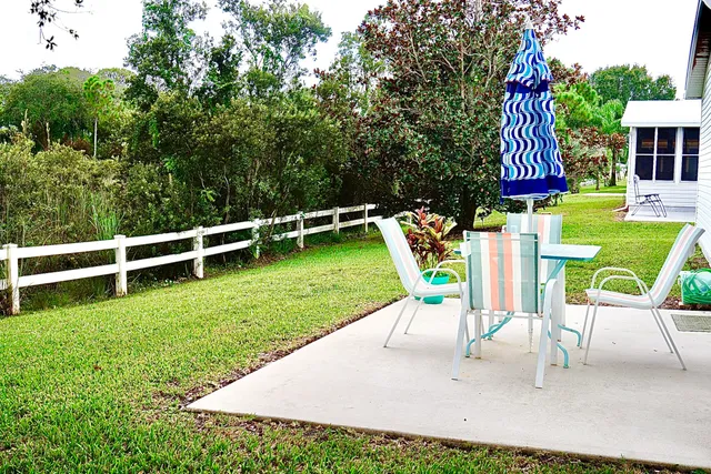 a view of a chairs and table in the garden