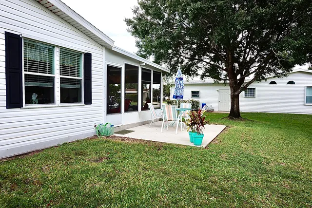a view of a house with sitting area and garden