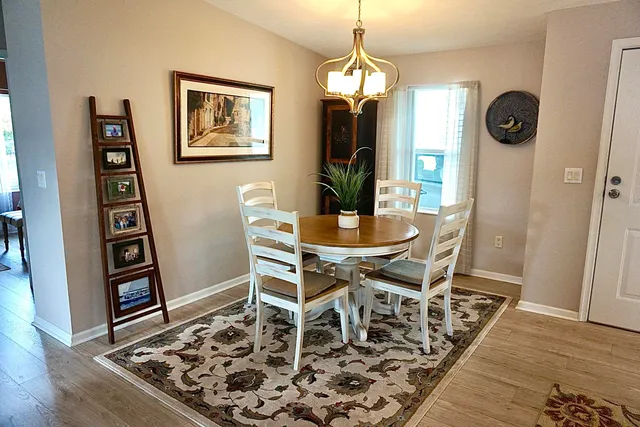 a view of a dining room with furniture and wooden floor