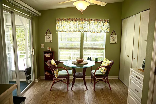 a dining room with furniture a chandelier and wooden floor