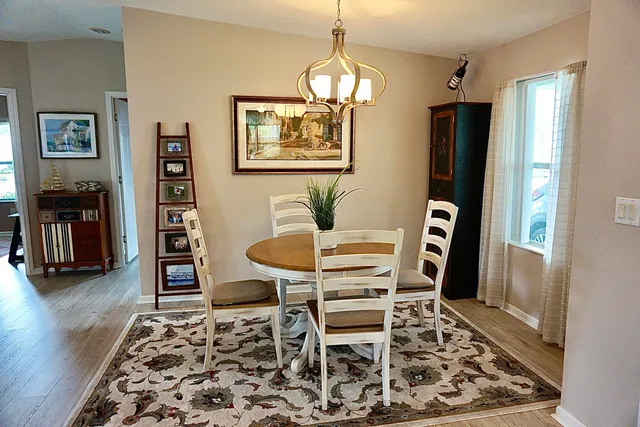 a dining room with furniture and wooden floor