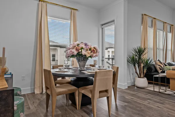 a dining room with furniture and wooden floor