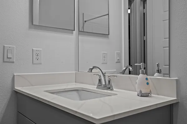 a view of a livingroom with wooden floor and furniture