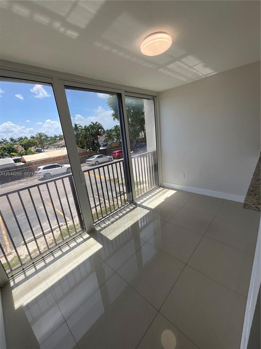 9441 Southwest 4th Street, Unit 214 Miami, FL 33174 - Photo 8 of 22 a view of a porch with a floor to ceiling window