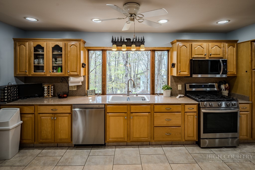 103-105 Upper Grouse Ridge Road Beech Mountain, NC 28604 - Photo 7 of 48 a kitchen with a stove a sink and a microwave