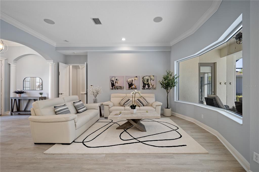 14721 Bowfin Terrace Lakewood Ranch, FL 34202 - Photo 16 of 50 a living room with furniture a rug and a chandelier