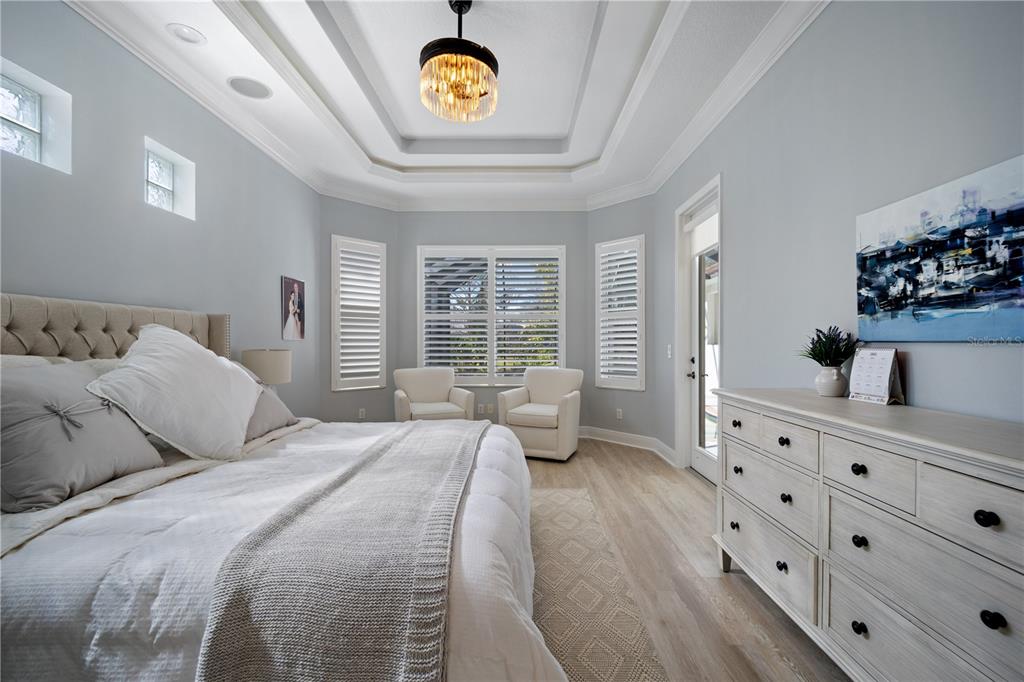 14721 Bowfin Terrace Lakewood Ranch, FL 34202 - Photo 22 of 50 a bedroom with a bed a dresser and next to a window