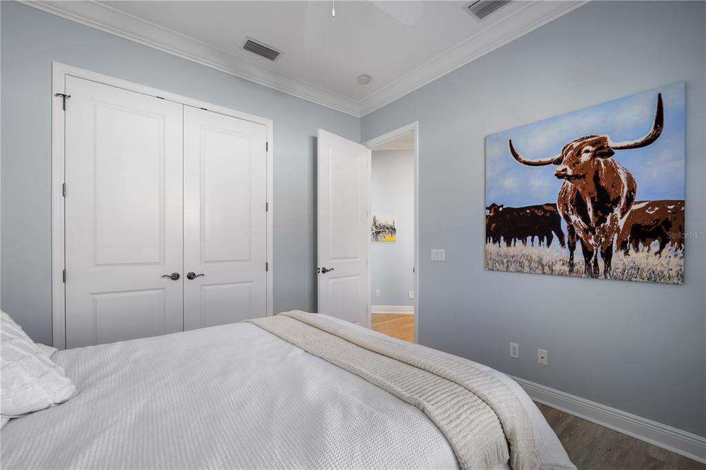 14721 Bowfin Terrace Lakewood Ranch, FL 34202 - Photo 28 of 50 a bedroom with a bed and a chandelier