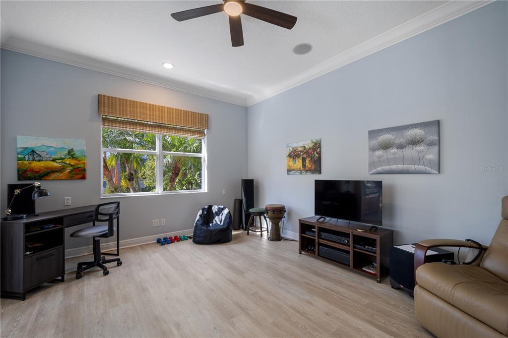 14721 Bowfin Terrace Lakewood Ranch, FL 34202 - Photo 35 of 50 a bedroom with furniture and a flat screen tv