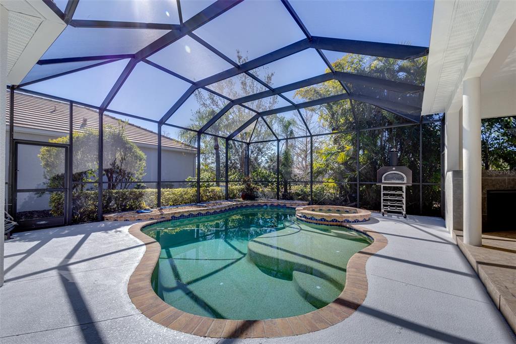 14721 Bowfin Terrace Lakewood Ranch, FL 34202 - Photo 45 of 50 a view of a couches in patio and a swimming pool