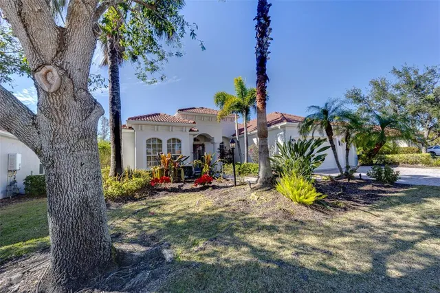 a view of a house with backyard and sitting area