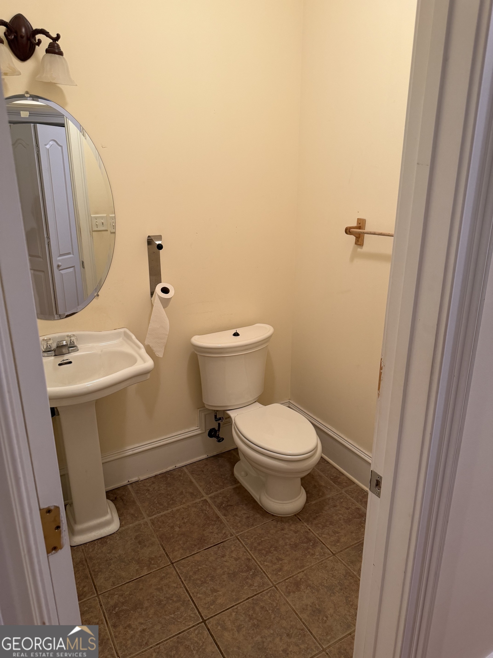 302 Norris Road Barnesville, GA 30204 - Photo 36 of 65 a white toilet sitting next to a white sink and vanity