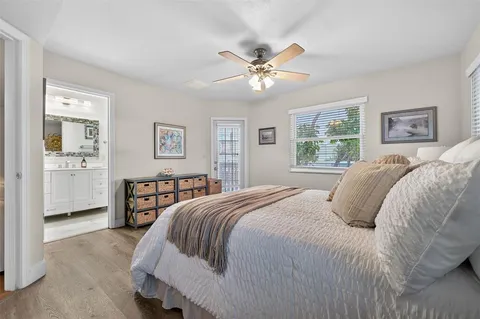 a bedroom with a large bed and a chandelier