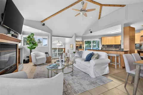 a living room with furniture fireplace and flat screen tv