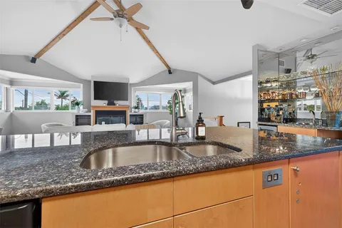 a kitchen with granite countertop a sink and a counter top space